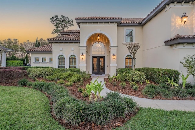 5914 Fitzgerald Rd, Odessa, FL 33556 - view of front of home featuring french doors, a tile roof, and stucco siding