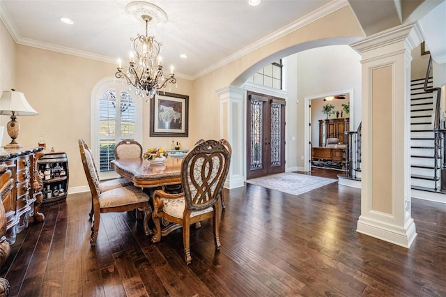 5914 Fitzgerald Rd, Odessa, FL 33556 - dining area with arched walkways, decorative columns, hardwood / wood-style floors, stairway, and a chandelier