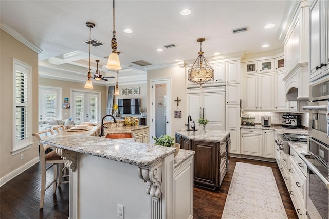 5914 Fitzgerald Rd, Odessa, FL 33556 - kitchen with a large island, appliances with stainless steel finishes, recessed lighting, dark wood finished floors, and a sink