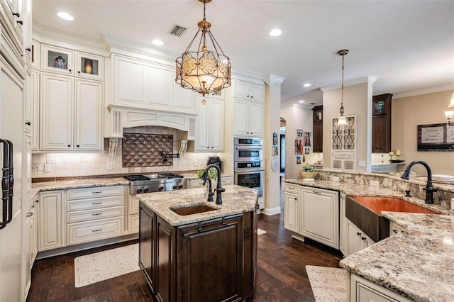 5914 Fitzgerald Rd, Odessa, FL 33556 - kitchen featuring a sink, appliances with stainless steel finishes, light stone countertops, decorative backsplash, and crown molding