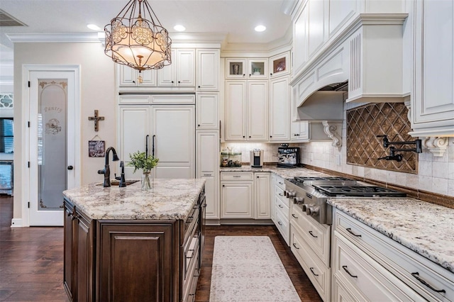 5914 Fitzgerald Rd, Odessa, FL 33556 - kitchen featuring stainless steel gas cooktop, paneled fridge, dark wood-type flooring, a chandelier, and light stone counters