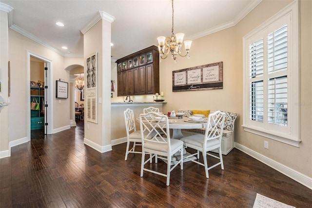 5914 Fitzgerald Rd, Odessa, FL 33556 - dining area with a chandelier, dark wood finished floors, arched walkways, baseboards, and crown molding
