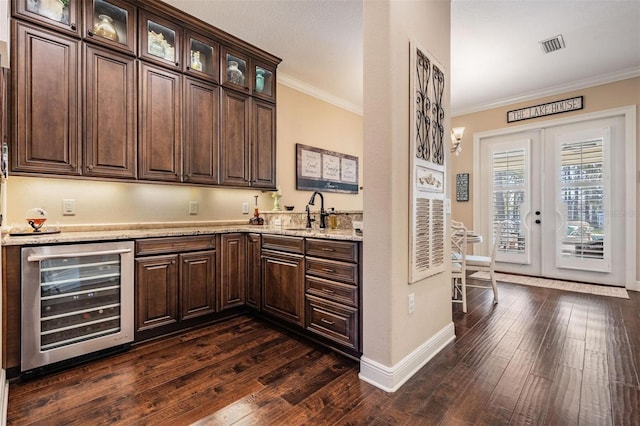 5914 Fitzgerald Rd, Odessa, FL 33556 - bar with wine cooler, crown molding, a sink, french doors, and baseboards