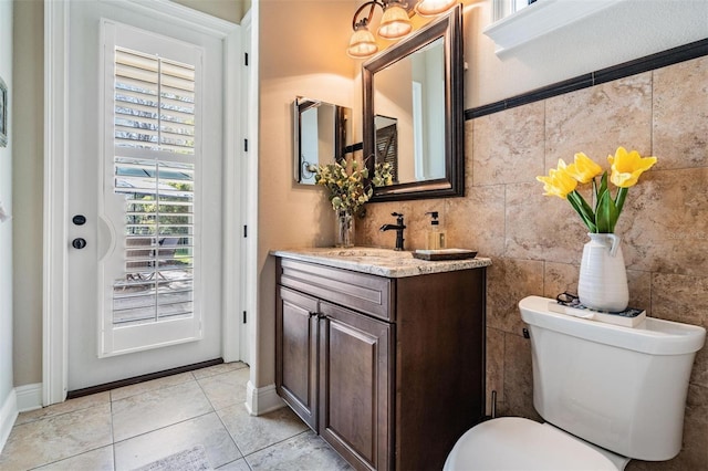 5914 Fitzgerald Rd, Odessa, FL 33556 - bathroom featuring toilet, vanity, tile patterned floors, and baseboards