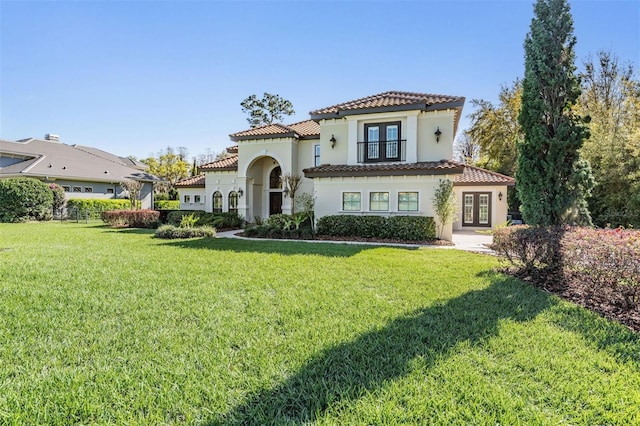 5914 Fitzgerald Rd, Odessa, FL 33556 - mediterranean / spanish home featuring french doors, a tile roof, stucco siding, and a front lawn