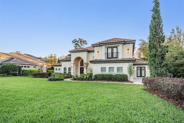5914 Fitzgerald Rd, Odessa, FL 33556 - mediterranean / spanish home with french doors, stucco siding, a front lawn, and a tiled roof