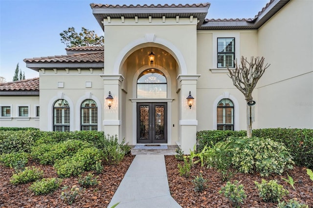 5914 Fitzgerald Rd, Odessa, FL 33556 - entrance to property featuring french doors, a tiled roof, and stucco siding