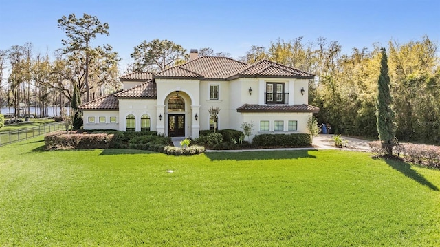 5914 Fitzgerald Rd, Odessa, FL 33556 - mediterranean / spanish-style house with french doors, a chimney, a tiled roof, and stucco siding