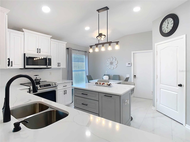 kitchen with marble finish floor, stainless steel appliances, a sink, and white cabinets