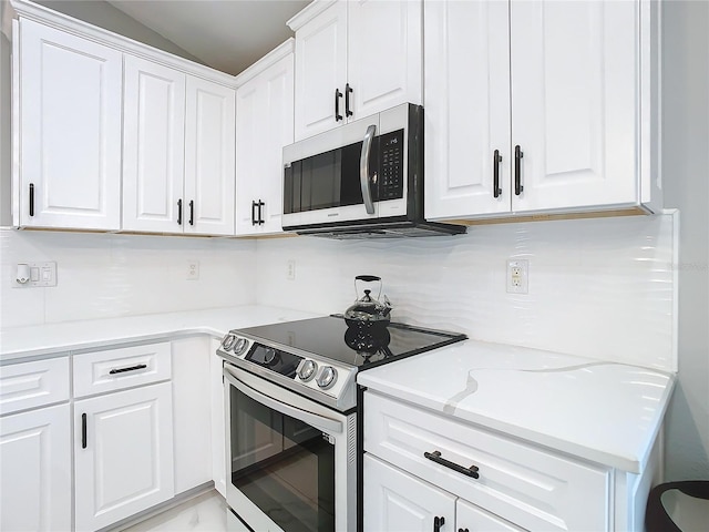 kitchen with appliances with stainless steel finishes and white cabinets