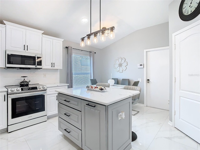 kitchen with marble finish floor, stainless steel appliances, lofted ceiling, and light countertops