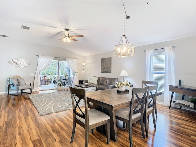 dining room featuring ceiling fan, baseboards, vaulted ceiling, and wood finished floors