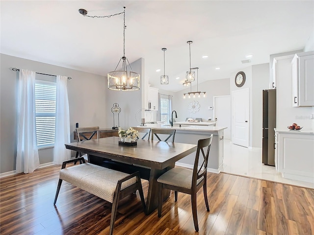 dining area with light wood-type flooring, vaulted ceiling, baseboards, and recessed lighting