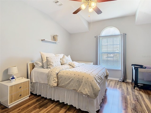 bedroom with baseboards, wood finished floors, visible vents, and a ceiling fan