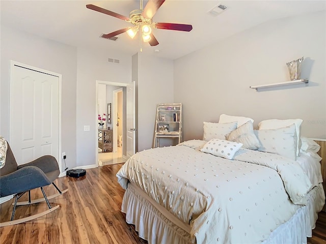 bedroom featuring a closet, wood finished floors, and visible vents