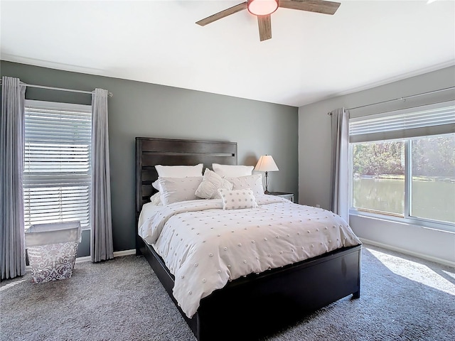 carpeted bedroom with a ceiling fan and baseboards