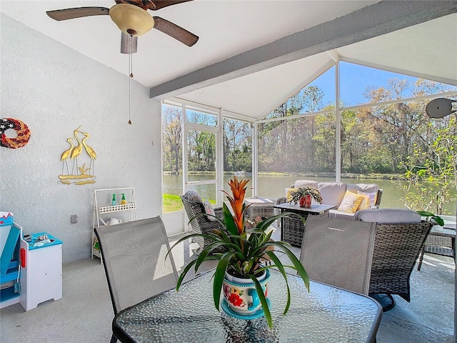 sunroom featuring vaulted ceiling with beams and a ceiling fan