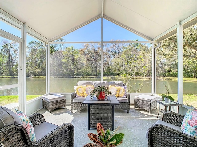 sunroom / solarium with a water view and lofted ceiling