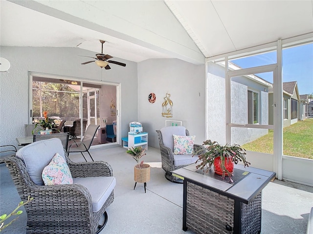 sunroom / solarium with lofted ceiling, plenty of natural light, and ceiling fan