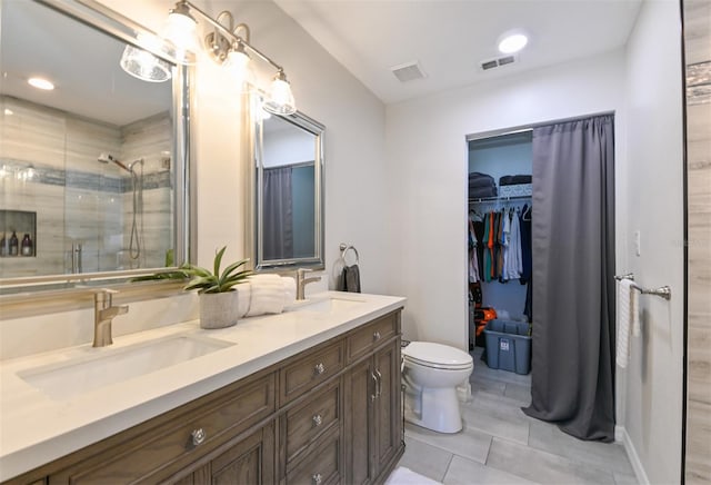 full bathroom featuring toilet, visible vents, a sink, and a stall shower