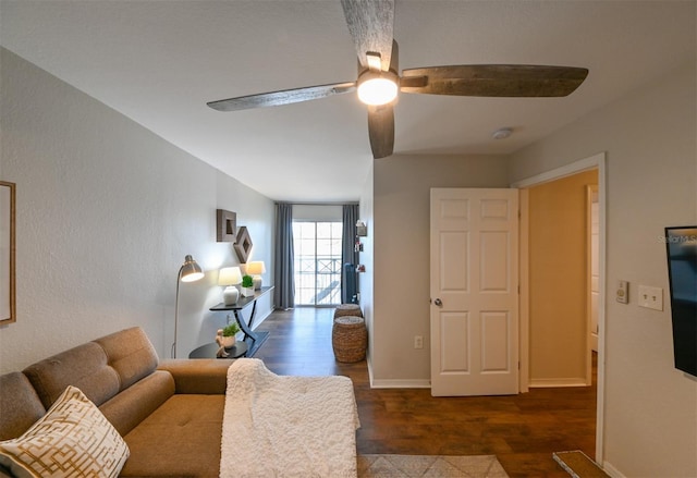living room with baseboards, wood finished floors, and ceiling fan