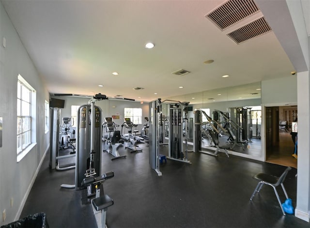 exercise room with recessed lighting, visible vents, and baseboards