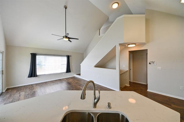 9730 Lake Chase Island Way Unit 9730, Tampa, FL 33626 - kitchen featuring a ceiling fan, light stone counters, dark wood-type flooring, open floor plan, and high vaulted ceiling