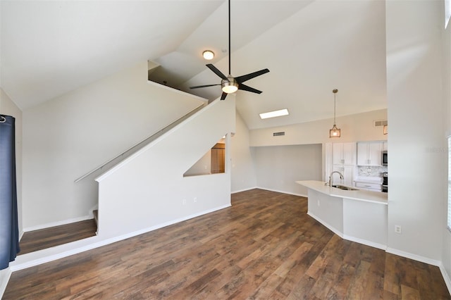 9730 Lake Chase Island Way Unit 9730, Tampa, FL 33626 - unfurnished living room featuring stairs, a ceiling fan, dark wood finished floors, and high vaulted ceiling