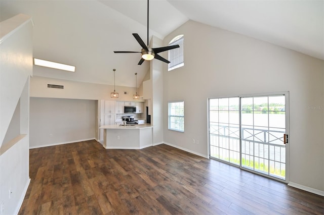 9730 Lake Chase Island Way Unit 9730, Tampa, FL 33626 - unfurnished living room featuring high vaulted ceiling, a ceiling fan, dark wood-style floors, and plenty of natural light