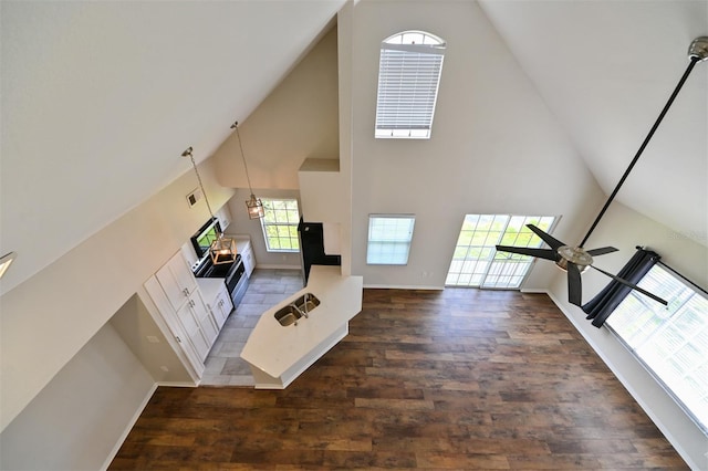9730 Lake Chase Island Way Unit 9730, Tampa, FL 33626 - unfurnished living room with high vaulted ceiling and wood finished floors