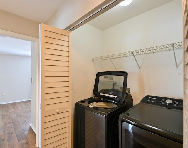 9730 Lake Chase Island Way Unit 9730, Tampa, FL 33626 - laundry area featuring separate washer and dryer and wood finished floors
