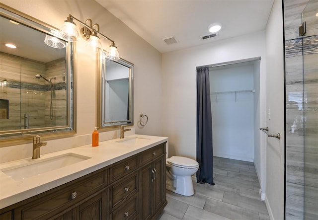 9730 Lake Chase Island Way Unit 9730, Tampa, FL 33626 - bathroom featuring a stall shower, double vanity, and a walk in closet