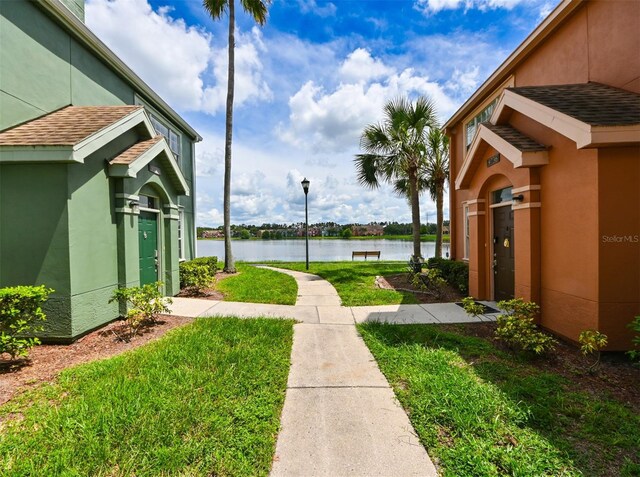 9730 Lake Chase Island Way Unit 9730, Tampa, FL 33626 - view of green lawn with a water view
