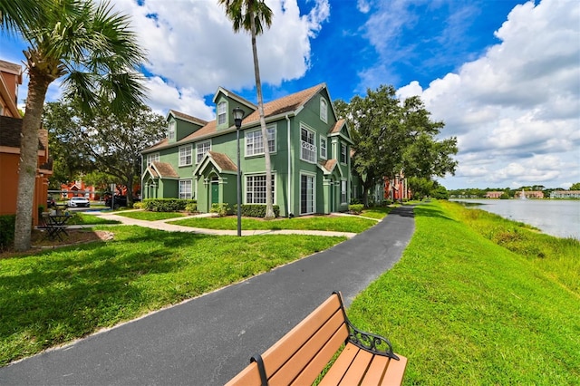 9730 Lake Chase Island Way Unit 9730, Tampa, FL 33626 - view of side of property featuring a water view, a lawn, and stucco siding