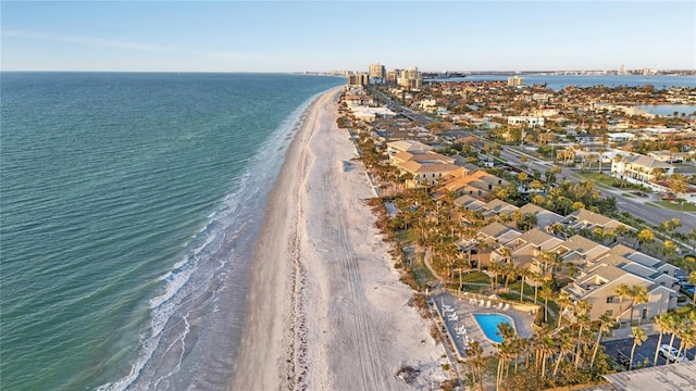 birds eye view of property with a water view and a beach view