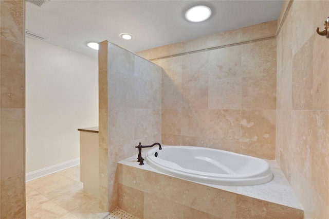 full bath featuring a garden tub, tile walls, visible vents, a textured ceiling, and tile patterned flooring