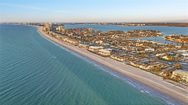 drone / aerial view featuring a view of the beach, a water view, and a view of city