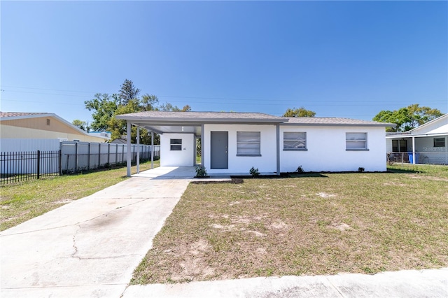 view of front of property with an attached carport, fence, stucco siding, concrete driveway, and a front lawn