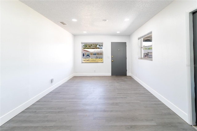 spare room with a healthy amount of sunlight, visible vents, and baseboards