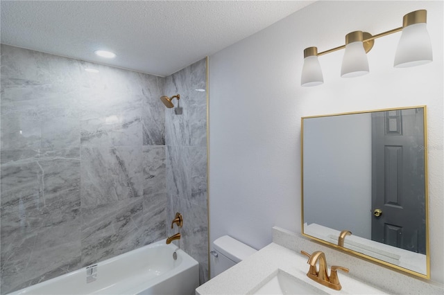 bathroom with vanity, a textured ceiling, washtub / shower combination, and toilet