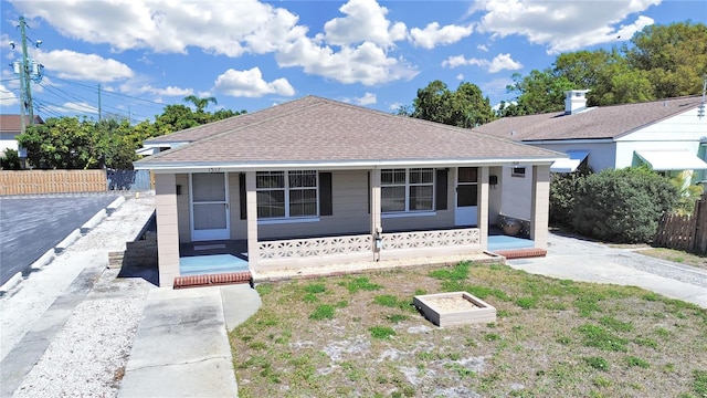 view of front of house with fence and roof with shingles