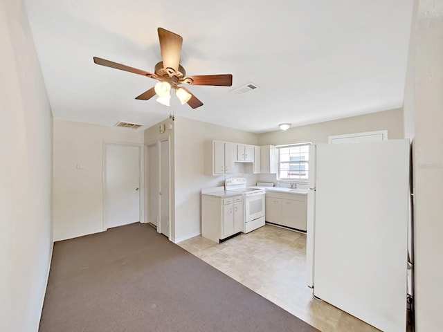 kitchen featuring white cabinetry, white appliances, light countertops, and visible vents