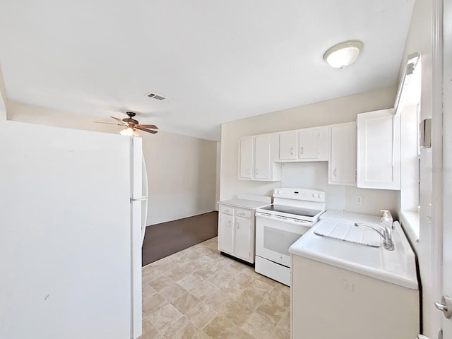 kitchen featuring visible vents, white appliances, and white cabinetry