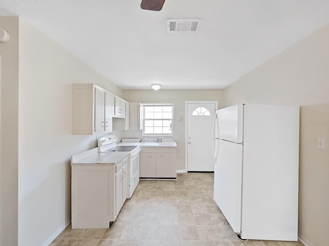 clothes washing area with baseboards, visible vents, laundry area, washer / clothes dryer, and a sink