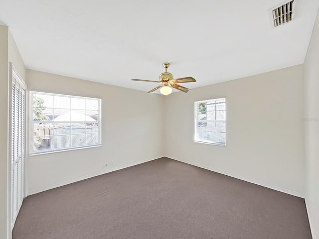 unfurnished room featuring visible vents, baseboards, and ceiling fan