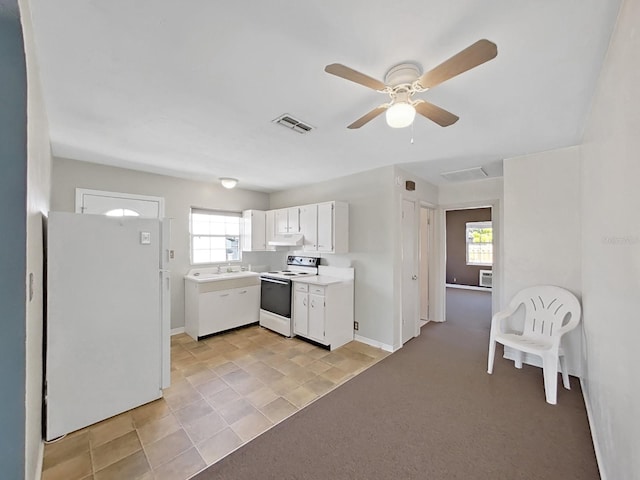 kitchen featuring visible vents, a sink, white appliances, white cabinets, and light countertops