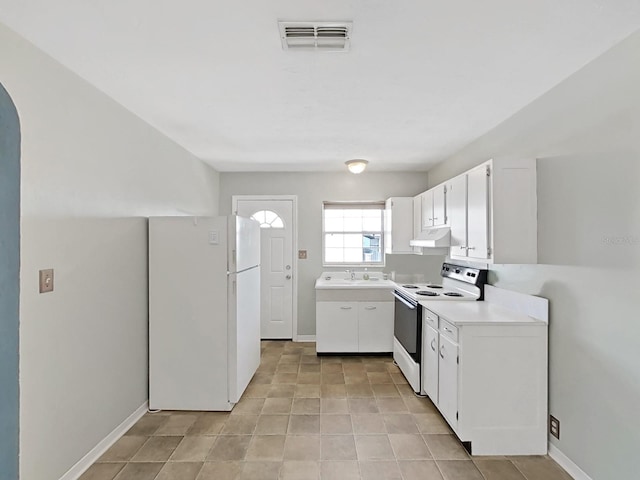 kitchen featuring visible vents, under cabinet range hood, light countertops, white appliances, and white cabinetry