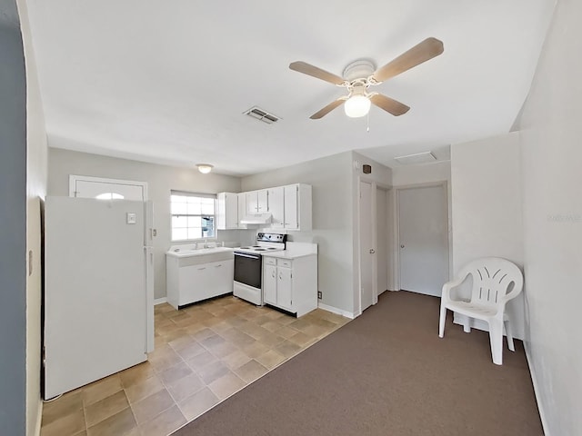 kitchen with visible vents, under cabinet range hood, light countertops, white cabinets, and white appliances