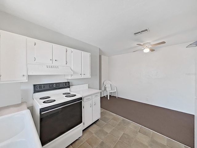 kitchen featuring visible vents, under cabinet range hood, light countertops, white electric stove, and white cabinetry