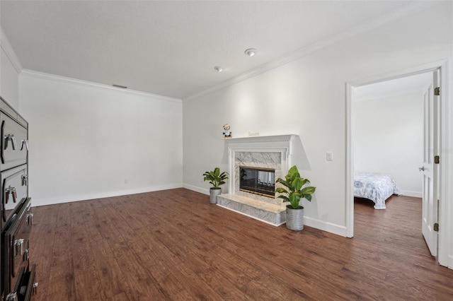 living room featuring ornamental molding, wood finished floors, baseboards, and a premium fireplace